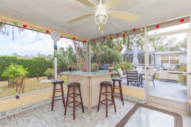 sunroom with ceiling fan and plenty of natural light