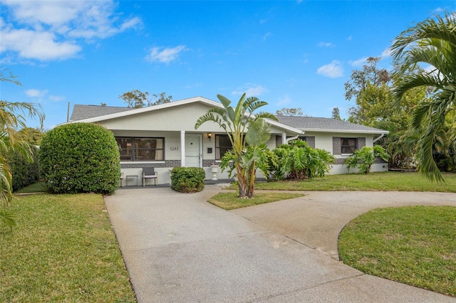 ranch-style house with covered porch and a front yard