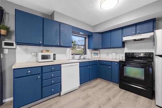 kitchen featuring light hardwood / wood-style floors, white appliances, a textured ceiling, and blue cabinets