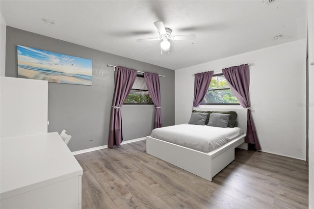 bedroom with ceiling fan and wood-type flooring