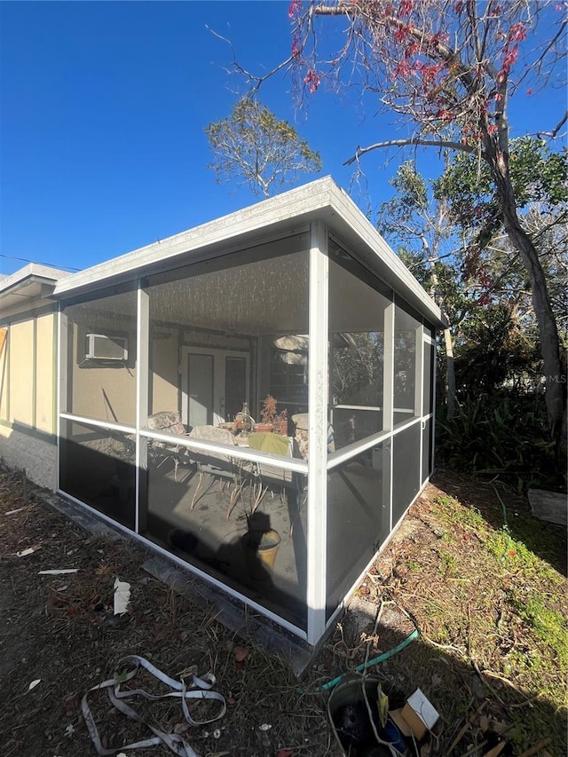 view of side of home featuring a sunroom