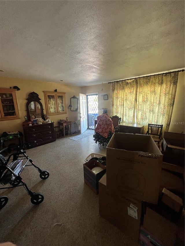 carpeted bedroom featuring access to outside and a textured ceiling