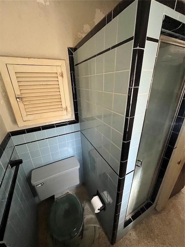 bathroom with tile walls and toilet