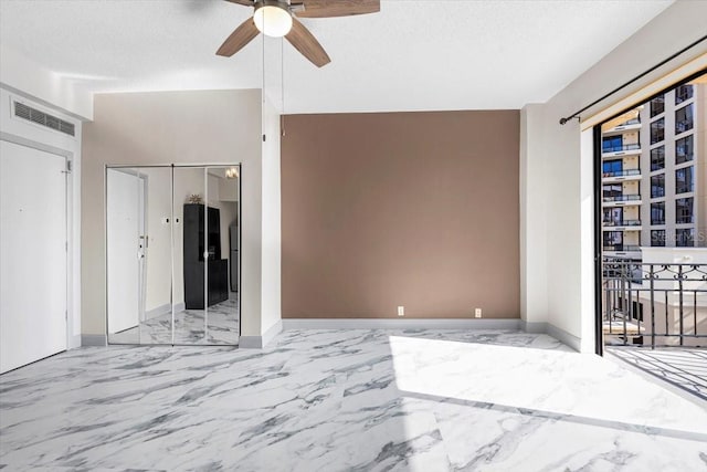 unfurnished room with a textured ceiling and ceiling fan