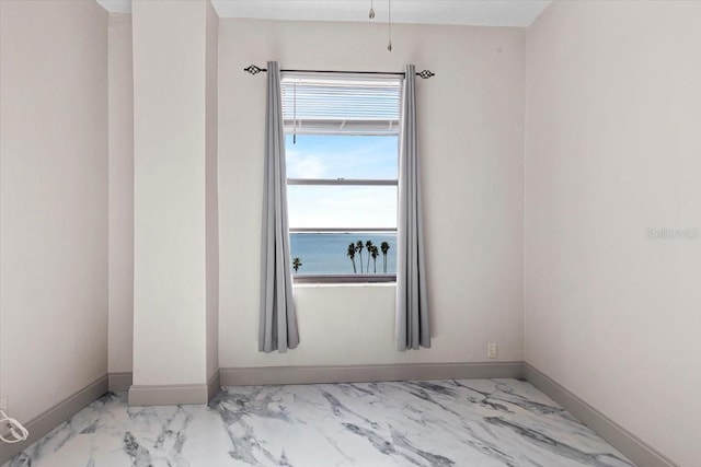 unfurnished room with a water view