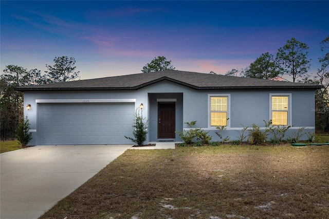 single story home with a yard and a garage