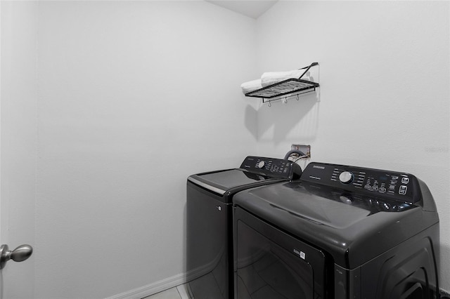 laundry area featuring separate washer and dryer and tile patterned floors