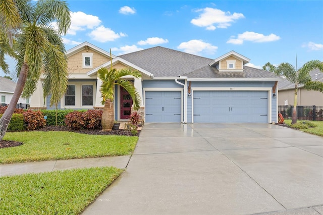 view of front of property featuring a garage and a front yard