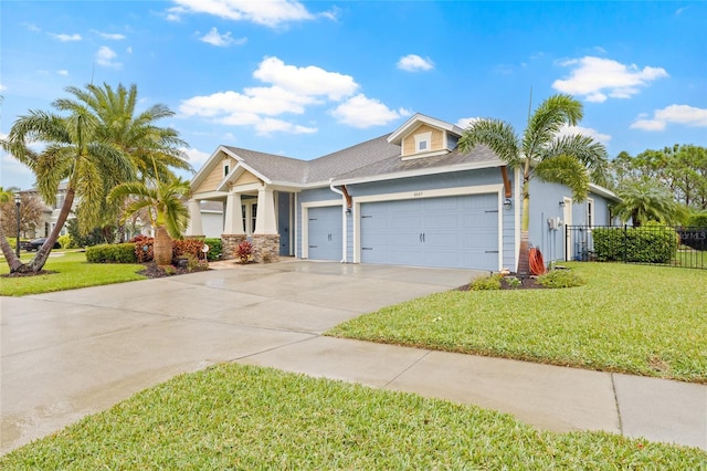 view of front of house with a front yard and a garage