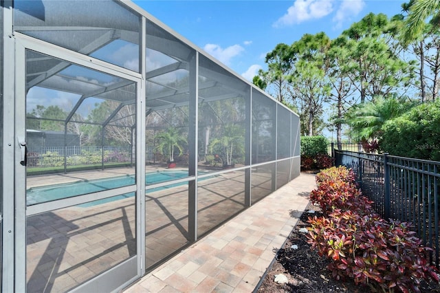 view of pool featuring a patio and glass enclosure