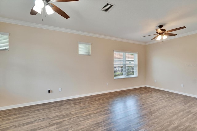 empty room featuring ornamental molding, hardwood / wood-style floors, and ceiling fan