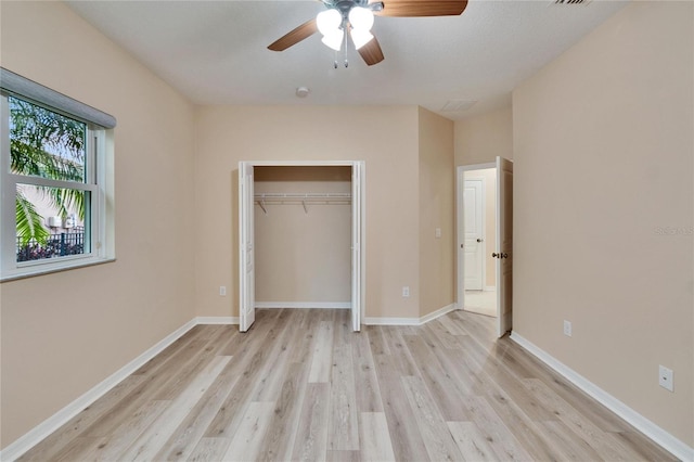 unfurnished bedroom with a closet, ceiling fan, and light wood-type flooring