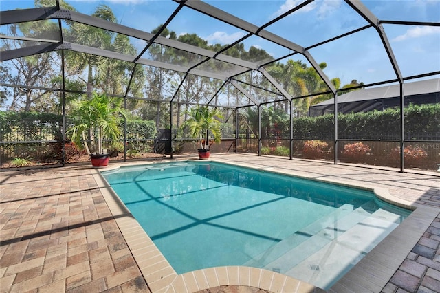 view of swimming pool featuring a lanai and a patio area