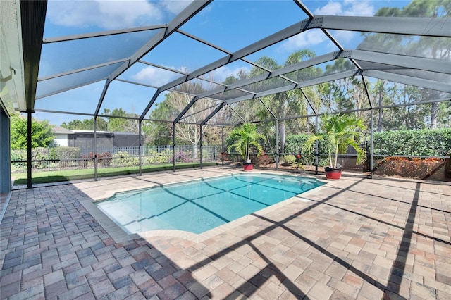 view of swimming pool with a patio area and glass enclosure