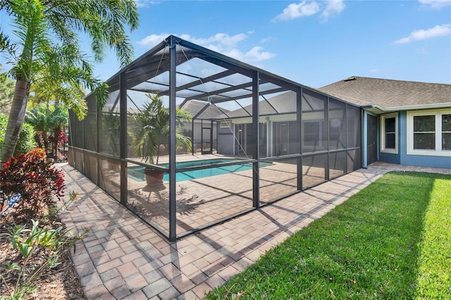 view of pool with a patio and glass enclosure