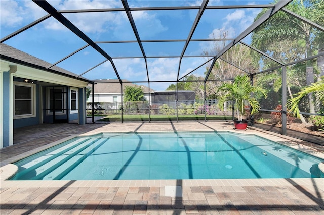 view of swimming pool with a patio area and glass enclosure