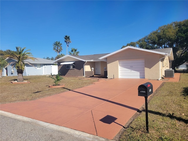 ranch-style house with central AC unit, a front yard, and a garage