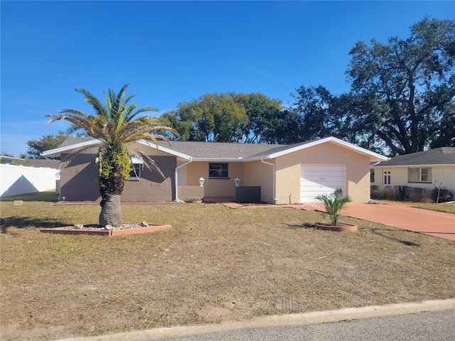 ranch-style home with a garage and a front yard