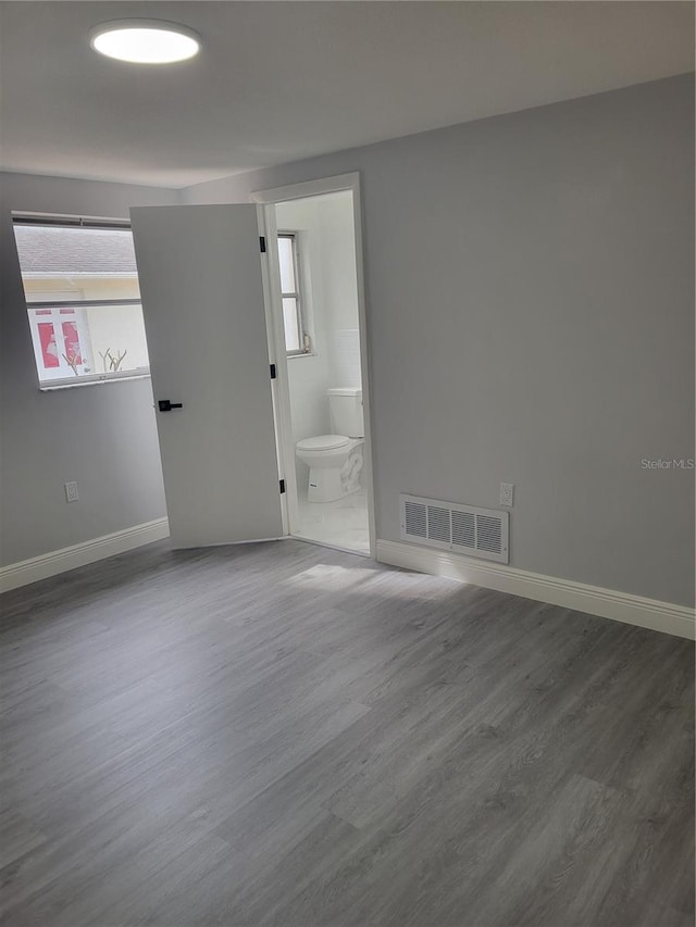 unfurnished room with dark hardwood / wood-style flooring