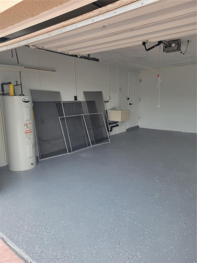 garage with electric water heater, sink, and a garage door opener