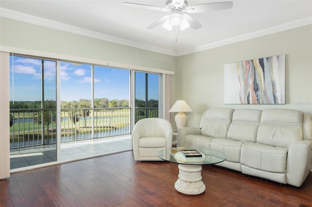 living room with ornamental molding, a water view, dark hardwood / wood-style floors, and ceiling fan