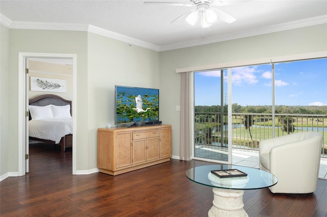 living room featuring ceiling fan, ornamental molding, and dark hardwood / wood-style floors