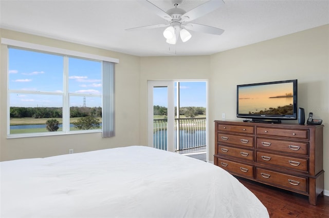 bedroom with access to exterior, dark hardwood / wood-style floors, and ceiling fan