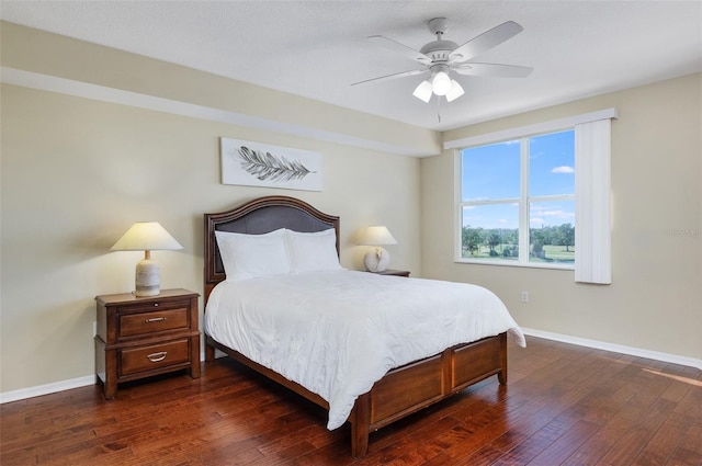 bedroom with dark hardwood / wood-style floors and ceiling fan