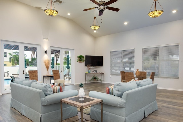 living room featuring wood-type flooring, ceiling fan, high vaulted ceiling, and french doors