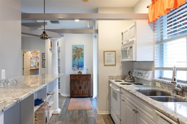 kitchen with sink, white appliances, white cabinetry, light stone countertops, and decorative light fixtures