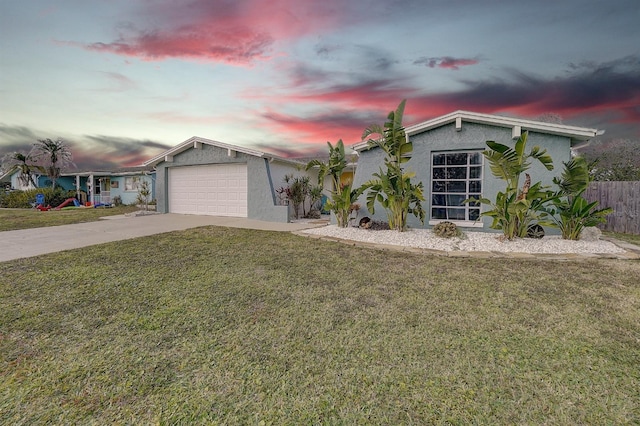 view of front of house with a garage and a yard