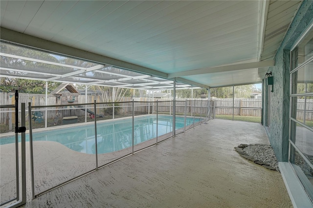 view of swimming pool featuring a lanai and a patio