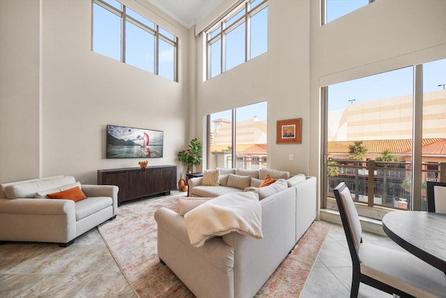 living room featuring a wealth of natural light and a high ceiling