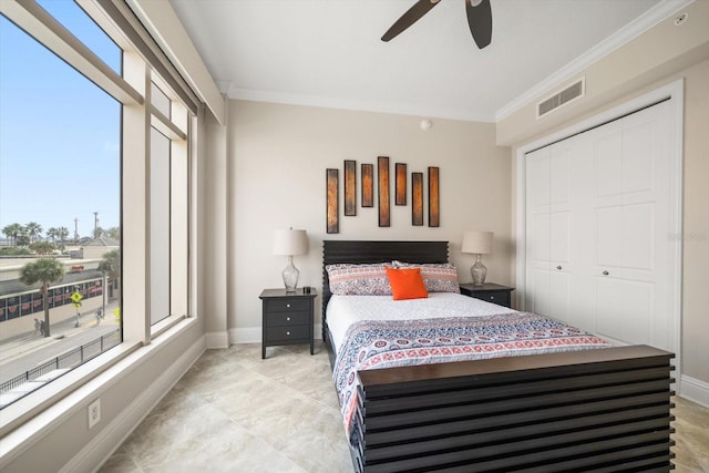 bedroom with ceiling fan, a closet, and crown molding