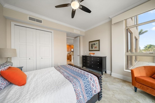 bedroom with a closet, ornamental molding, and ceiling fan