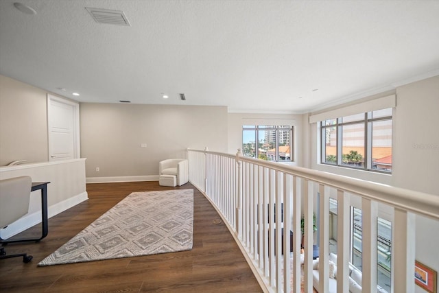 hall with dark hardwood / wood-style flooring and ornamental molding