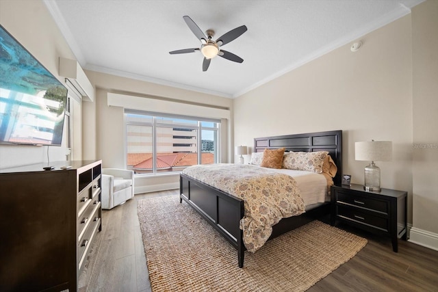 bedroom featuring dark wood-type flooring, ceiling fan, and crown molding