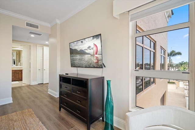 interior space with crown molding and hardwood / wood-style flooring