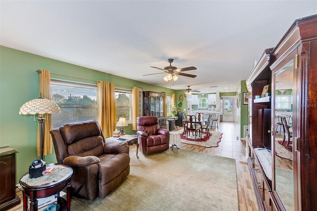 living room with ceiling fan and a wealth of natural light