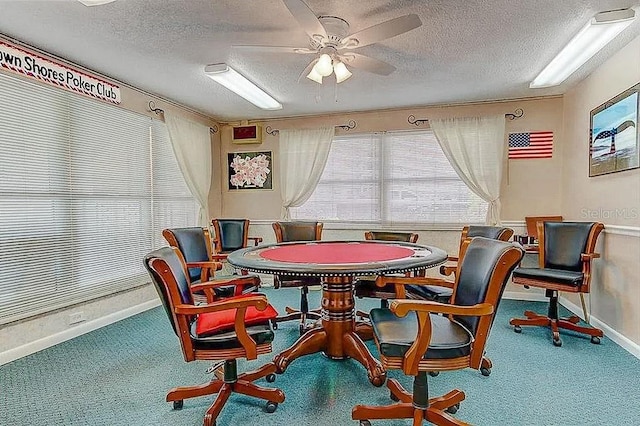 playroom with ceiling fan, a textured ceiling, and carpet flooring