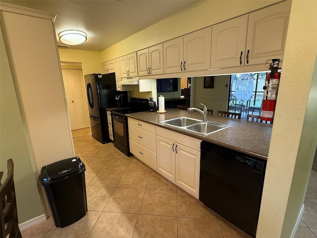 kitchen featuring black appliances, white cabinetry, light tile patterned floors, and sink