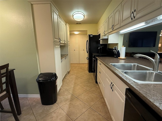 kitchen with black appliances, light tile patterned flooring, and sink