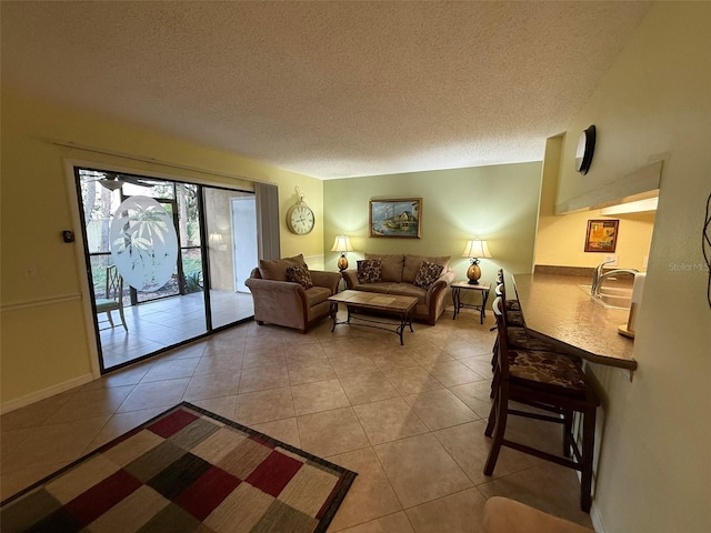 tiled living room featuring a textured ceiling