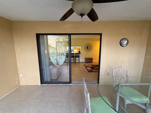 view of exterior entry featuring ceiling fan