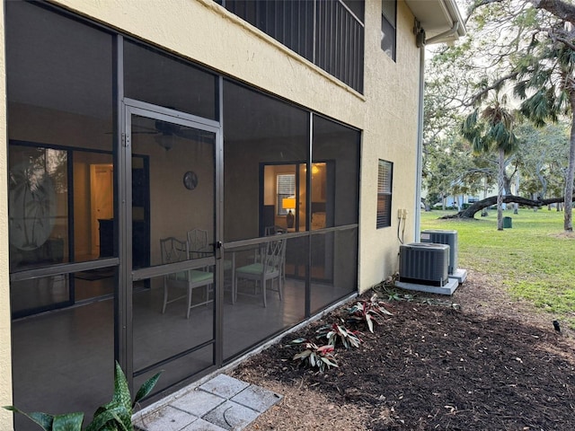 exterior space with a sunroom and central AC