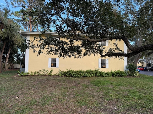 view of property exterior with a lawn