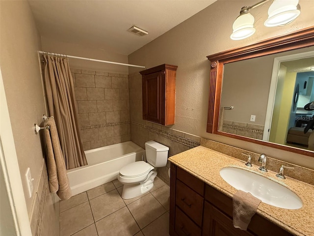 full bathroom featuring tile patterned floors, toilet, vanity, and shower / bath combination with curtain