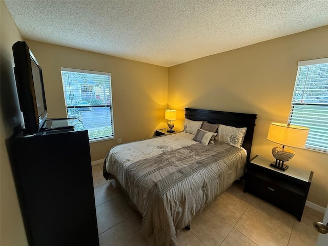 bedroom featuring a textured ceiling and light tile patterned flooring