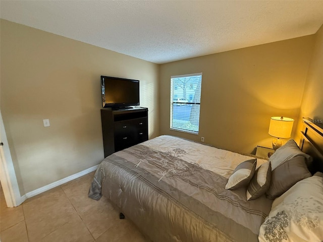 bedroom featuring a textured ceiling and light tile patterned flooring