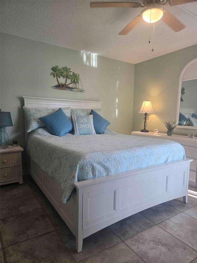 bedroom with a textured ceiling and ceiling fan